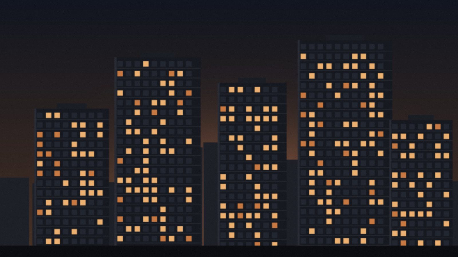 Residential towers at dusk with lit apartment windows